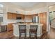 Bright kitchen with a central island, stainless steel appliances, and wooden cabinets at 5330 W Morgan Pl, Chandler, AZ 85226