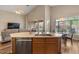 Bright kitchen with a central island, stainless steel appliances, breakfast nook and living room at 5330 W Morgan Pl, Chandler, AZ 85226