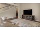 Cozy living room featuring a staircase, decorative rug, and entertainment center at 5330 W Morgan Pl, Chandler, AZ 85226