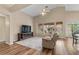 Spacious living room featuring laminate flooring, large windows, and comfortable seating at 5330 W Morgan Pl, Chandler, AZ 85226