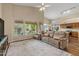 Open-concept living room with laminate floors, modern furniture, and large windows at 5330 W Morgan Pl, Chandler, AZ 85226
