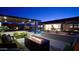 Beautifully landscaped backyard with a pool, waterfall feature, fire pit, and comfortable seating areas at 5457 S Benton --, Mesa, AZ 85212