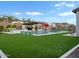 Expansive backyard featuring a sparkling pool, lush artificial turf, and a stylish outdoor living space at 5457 S Benton --, Mesa, AZ 85212