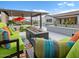 Backyard oasis featuring a cozy outdoor living area with a fireplace, pool, and lush landscaping at 5457 S Benton --, Mesa, AZ 85212