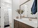 Well-lit bathroom featuring a large mirror, modern vanity, and a shower-tub combination, offering convenience and style at 5457 S Benton --, Mesa, AZ 85212
