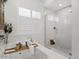 Bright bathroom with a soaking tub, separate glass-enclosed shower, and white subway tile at 5457 S Benton --, Mesa, AZ 85212
