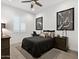 Comfortable bedroom with a ceiling fan, modern decor, and plantation shutters providing a serene and restful ambiance at 5457 S Benton --, Mesa, AZ 85212