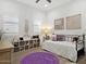 Cozy bedroom with decor, a purple rug, and ample natural light from plantation-shuttered windows at 5457 S Benton --, Mesa, AZ 85212
