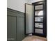 Modern entryway showcasing stylish black front door, trim, and a glimpse of the home's interior at 5457 S Benton --, Mesa, AZ 85212