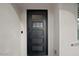 Stylish black front door with glass panels, complementing the home's modern exterior at 5457 S Benton --, Mesa, AZ 85212