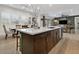 Kitchen island with bar stool seating and pendant lighting overlooking living area at 5457 S Benton --, Mesa, AZ 85212