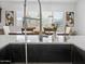 Kitchen island sink featuring stainless steel faucet and views of dining area at 5457 S Benton --, Mesa, AZ 85212