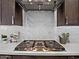 Close-up of range with stainless steel hood and white herringbone backsplash at 5457 S Benton --, Mesa, AZ 85212