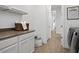 Efficient laundry room with white cabinets, folding counter, and modern washer and dryer at 5457 S Benton --, Mesa, AZ 85212
