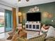 Well-lit living room with entertainment center, couch, and decorative accents at 5457 S Benton --, Mesa, AZ 85212