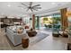 Open-concept living room with tile flooring, leading to outdoor patio and dining area at 5457 S Benton --, Mesa, AZ 85212