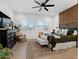Bright main bedroom featuring wood-look floors, designer wall, and a large window with plantation shutters at 5457 S Benton --, Mesa, AZ 85212