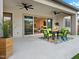 Inviting covered patio with dining set and seamless indoor-outdoor flow through sliding glass doors at 5457 S Benton --, Mesa, AZ 85212