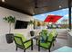 Charming outdoor living space with stylish seating, a TV, and manicured greenery for a private retreat at 5457 S Benton --, Mesa, AZ 85212