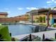 Stunning backyard pool with water feature, covered patio, and lounge seating; perfect for outdoor entertaining at 5457 S Benton --, Mesa, AZ 85212