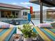 Stunning pool with waterfall feature and outdoor lounge area with comfortable seating and manicured landscaping at 5457 S Benton --, Mesa, AZ 85212