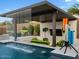 Inviting outdoor pool area with waterfall feature, comfortable seating, and entertainment setup at 5457 S Benton --, Mesa, AZ 85212