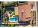 Bird's eye view of a private backyard featuring a sparkling pool, covered patio, lush landscaping, and outdoor kitchen at 5831 W Saragosa St, Chandler, AZ 85226