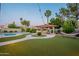 Outdoor oasis featuring a pool, manicured artificial turf, a gazebo with grill, palm trees, and patio lights at 5831 W Saragosa St, Chandler, AZ 85226