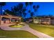 Backyard oasis featuring a built-in grill, outdoor seating, hammock, paver patio, and synthetic grass at 5831 W Saragosa St, Chandler, AZ 85226