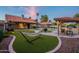 Relaxing backyard with gazebo, hammock, swing, pool, artificial turf and desert landscaping with mature trees at 5831 W Saragosa St, Chandler, AZ 85226