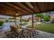 Enjoy a serene backyard featuring an outdoor lounge area, gazebo with a grill, pool, and lush, artificial turf at 5831 W Saragosa St, Chandler, AZ 85226