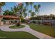 The backyard features a gazebo with a built-in grill, dining area, hammock, swing, artificial turf and desert landscaping at 5831 W Saragosa St, Chandler, AZ 85226