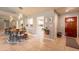 Hallway with open access to the kitchen, a formal dining table, and neutral paint at 5831 W Saragosa St, Chandler, AZ 85226