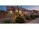 Charming single-story home with desert landscaping, lighting, and a terra cotta roof at dusk at 5831 W Saragosa St, Chandler, AZ 85226