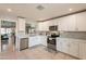 Bright kitchen with white cabinets, tile backsplash, stainless steel appliances, and tile floors at 5831 W Saragosa St, Chandler, AZ 85226