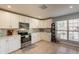Bright kitchen with white cabinets, tile backsplash, stainless steel appliances, and tile floors at 5831 W Saragosa St, Chandler, AZ 85226