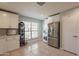 Bright kitchen features white cabinetry, stainless steel appliances, tile floors, and ample counter space at 5831 W Saragosa St, Chandler, AZ 85226