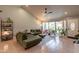 Bright living room with vaulted ceiling, neutral paint, tile floors, and large windows at 5831 W Saragosa St, Chandler, AZ 85226