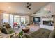 Bright living room with vaulted ceiling, neutral paint, fireplace, tile floors, and views of the front yard at 5831 W Saragosa St, Chandler, AZ 85226