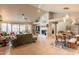 Bright living room with vaulted ceiling, neutral paint, fireplace, tile floors, and views of the backyard at 5831 W Saragosa St, Chandler, AZ 85226