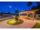 Outdoor kitchen featuring a built-in grill, pergola, desert landscaping, and paver patio at 5831 W Saragosa St, Chandler, AZ 85226