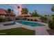 Inviting backyard pool surrounded by artificial turf and desert landscaping for outdoor enjoyment at 5831 W Saragosa St, Chandler, AZ 85226