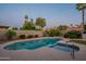 Inviting pool with integrated spa and lush desert landscaping surrounded by block wall fencing at 5831 W Saragosa St, Chandler, AZ 85226