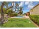 Expansive backyard with a well-maintained lawn, mature trees, and a sparkling pool at 6011 N 2Nd St, Phoenix, AZ 85012
