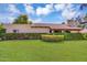 Charming single-story home featuring desert landscaping and mature shrubbery, set against a bright sky at 6011 N 2Nd St, Phoenix, AZ 85012