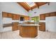 Bright, modern kitchen with granite countertops, center island, tile flooring, and wooden cabinetry at 6011 N 2Nd St, Phoenix, AZ 85012