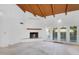 Bright living room featuring a fireplace and access to the outside through large windows, perfect for entertaining at 6011 N 2Nd St, Phoenix, AZ 85012