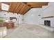 Open concept living area with vaulted ceilings, fireplace, and kitchen island featuring modern lighting fixtures at 6011 N 2Nd St, Phoenix, AZ 85012