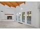 Living room with a cozy fireplace and large windows offering plenty of natural light and views of the outdoor greenery at 6011 N 2Nd St, Phoenix, AZ 85012