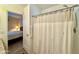 Bathroom showing shower with curtain and a view into the bedroom at 650 N Hawes Rd # 2827, Mesa, AZ 85207